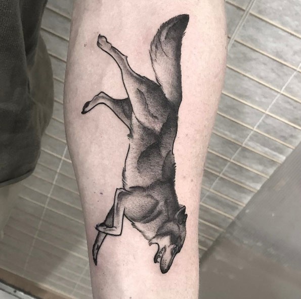 Dot style accurate looking forearm tattoo of running wolf