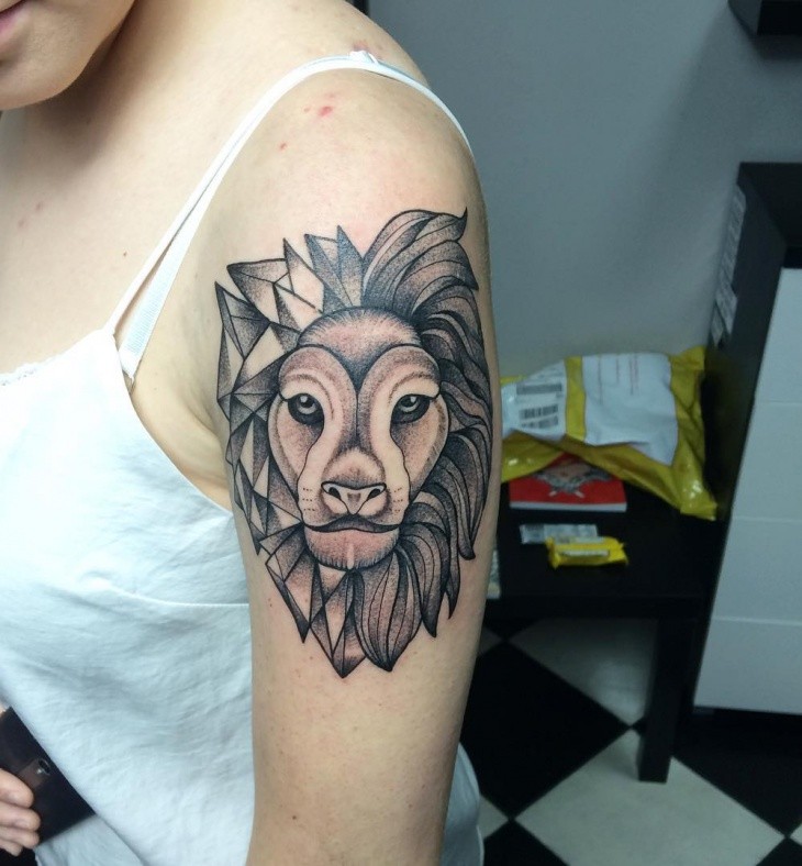 Dot style black ink shoulder tattoo of big lion head