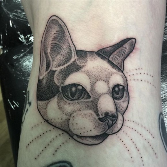 Dot style black ink tattoo of cute cat face