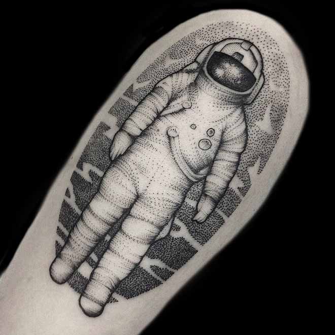 Dotwork style black ink shoulder tattoo of astronaut