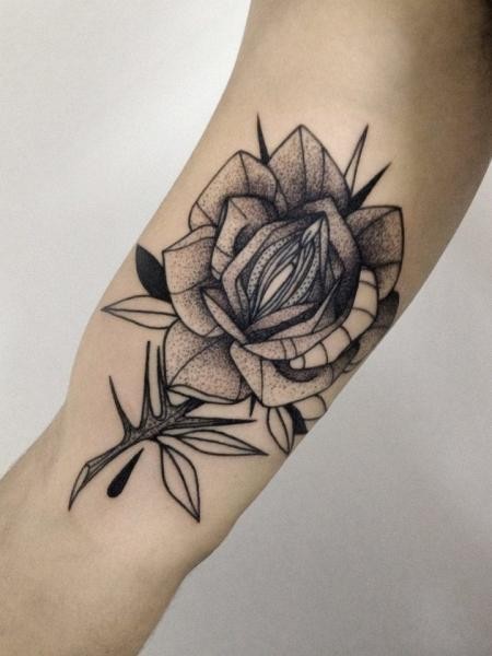 Dotwork style cool looking biceps tattoo of of small rose by Michele Zingales