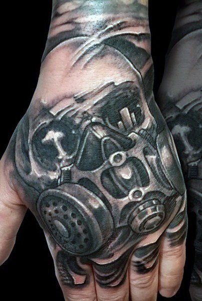 Dramatic black and white hand tattoo of skull in gas mask
