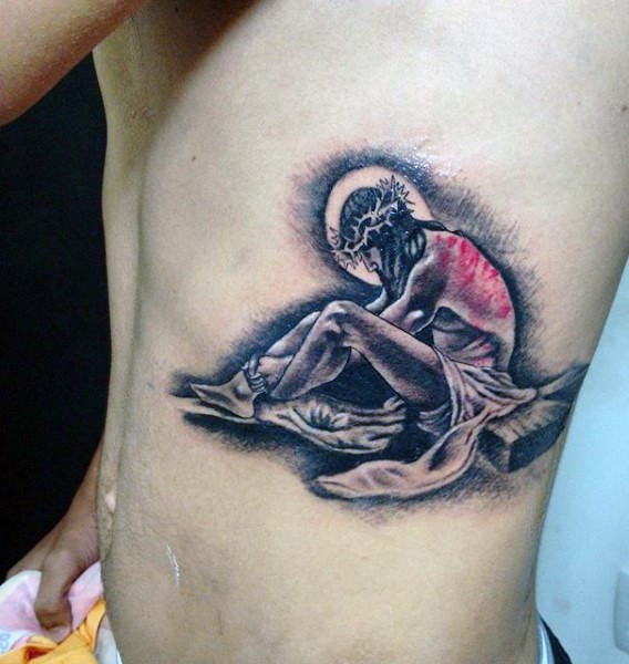 Dramatic black and white side tattoo of sad Jesus with cross