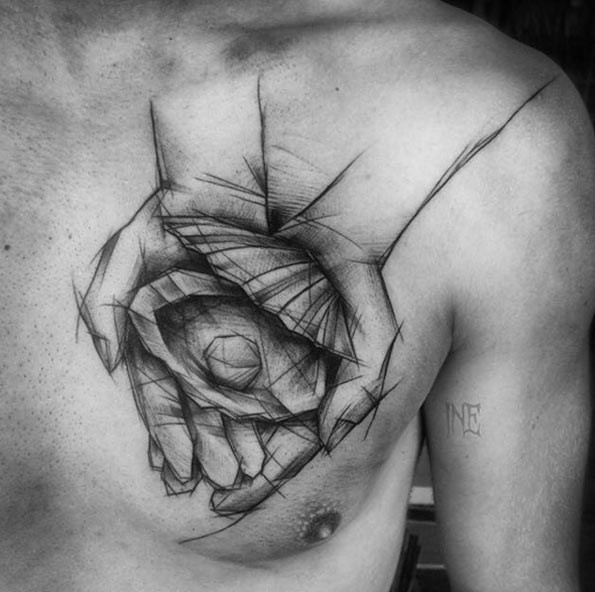 Dramatic black ink painted by Inez Janiak chest tattoo of hands holding shell with pearl
