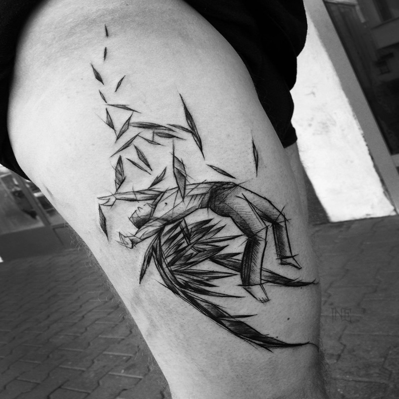 Dramatic blackwork style thigh tattoo of falling angel