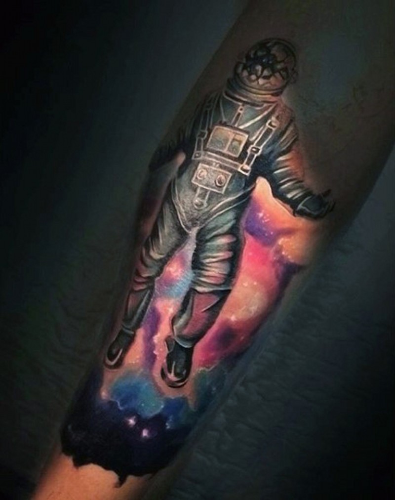 Dramatic designed colored astronaut with broken helmet tattoo on arm