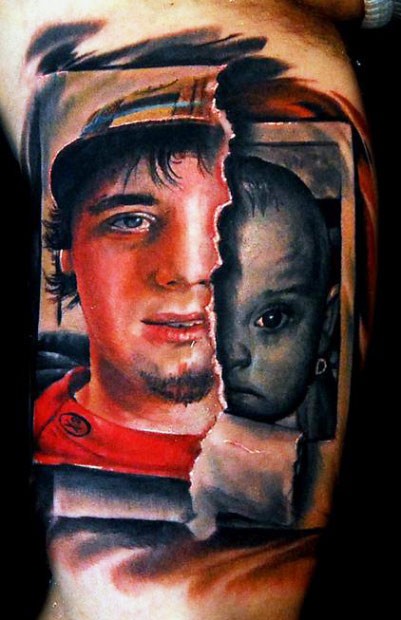 Dramatic looking colored biceps tattoo of man and baby photos