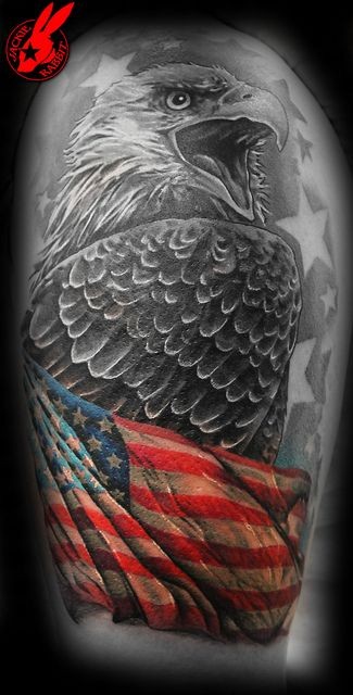 Eagle wrapped in american flag tattoo on arm