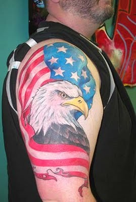 Eagle wrapped in usa flag tattoo on shoulder