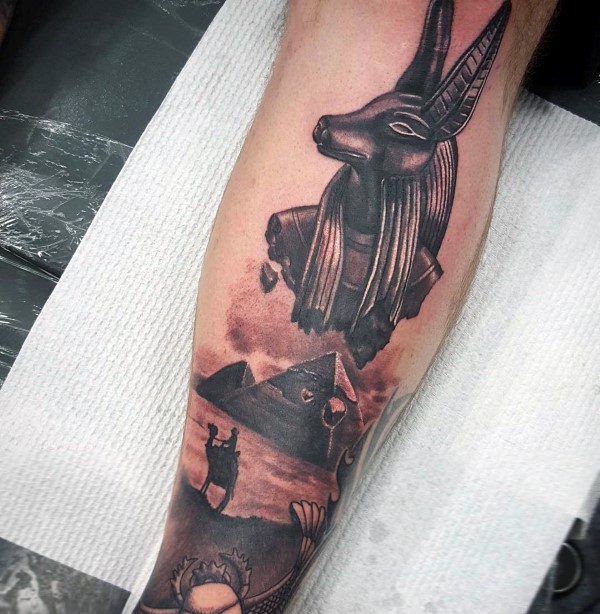 Egypt themed black and gray style leg tattoo of big pyramids and statues