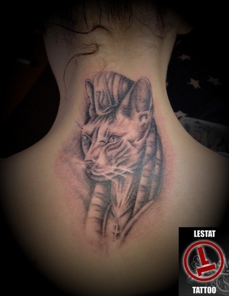 Egypt themed black ink upper back tattoo of mystical cat