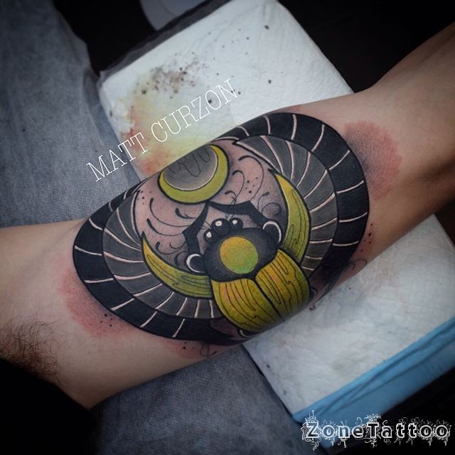 Egypt themed colored biceps tattoo of big Bug with symbols