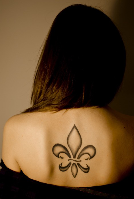 Elegant black fleur de lis tattoo on back for girls