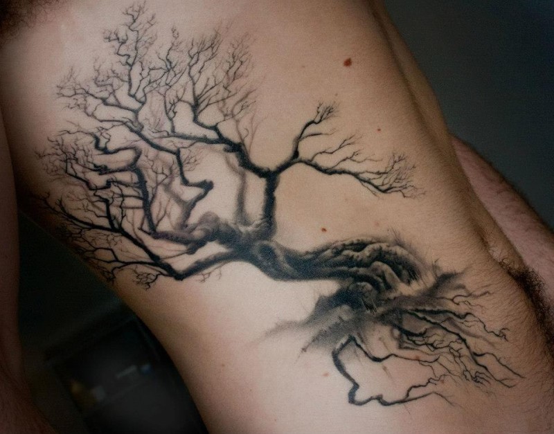 Elegant black tree tattoo on ribs