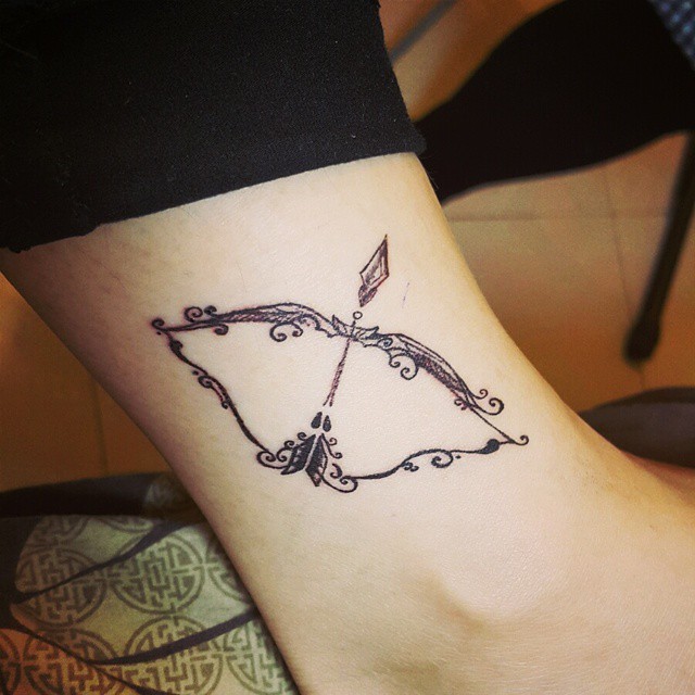 Elegant bow and arrow Sagittarius symbol designed ankle tattoo ...