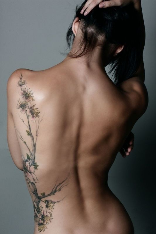 Elegant cherry blossoms tattoo on ribs