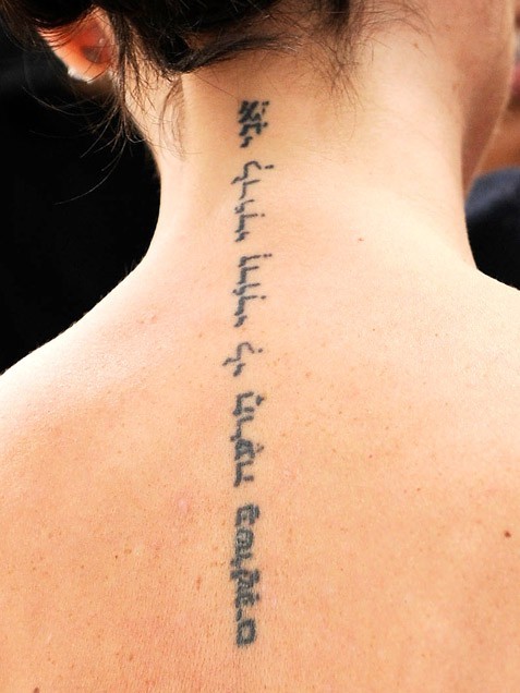 Elegant hebrew tattoo on back for girls