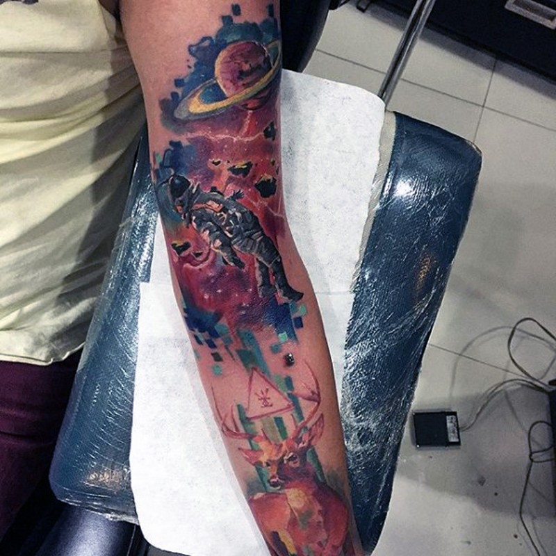 Elegant painted and colored space themed tattoo on arm