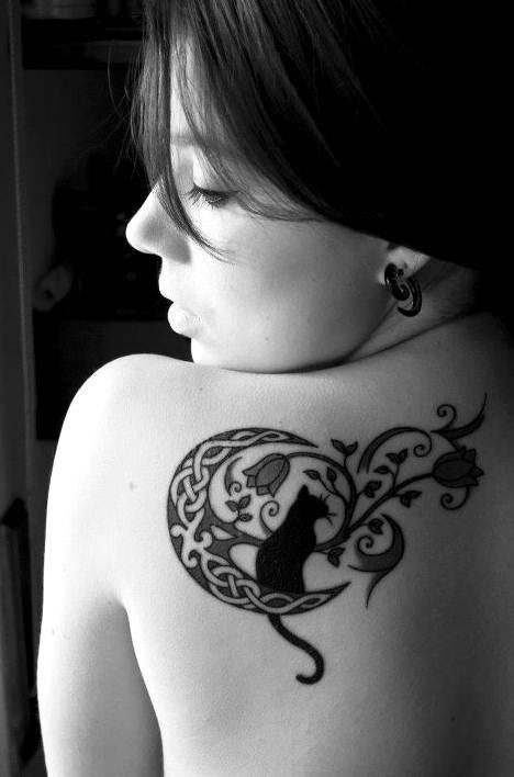 Elegant patchwork cat sitting on moon tattoo on back