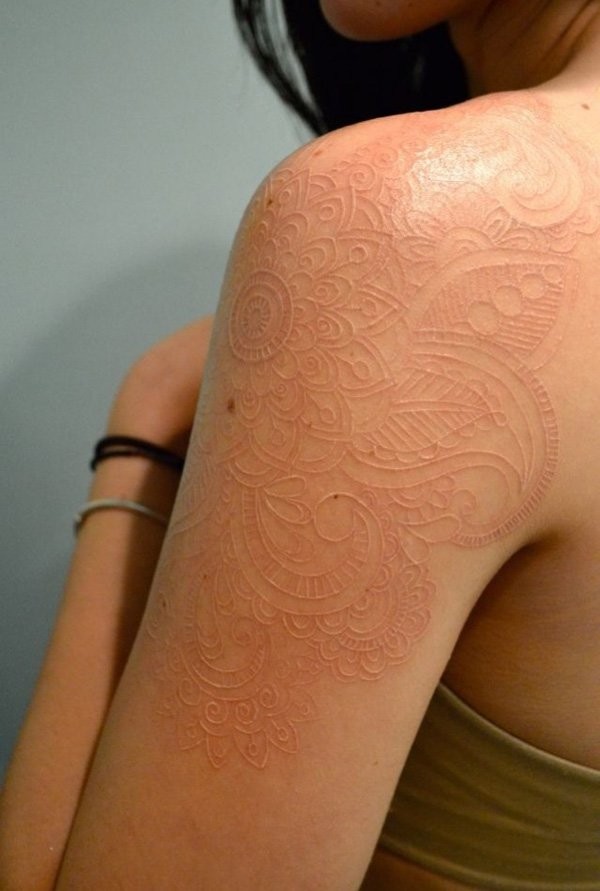 Elegant white ink tattoo on shoulder