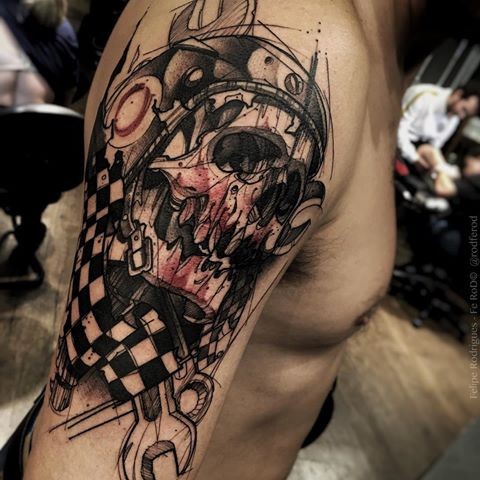 Engarving style black ink shoulder tattoo of big racer skull with helmet and tools