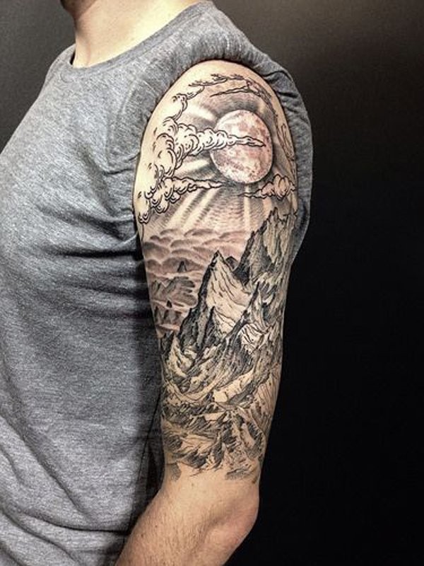 Engraving style black and white shoulder tattoo of mountains with sun