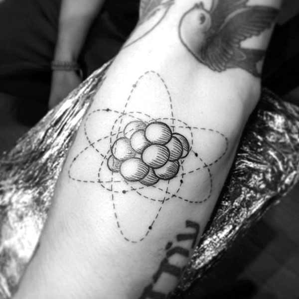 Engraving style black ink arm tattoo of big atom