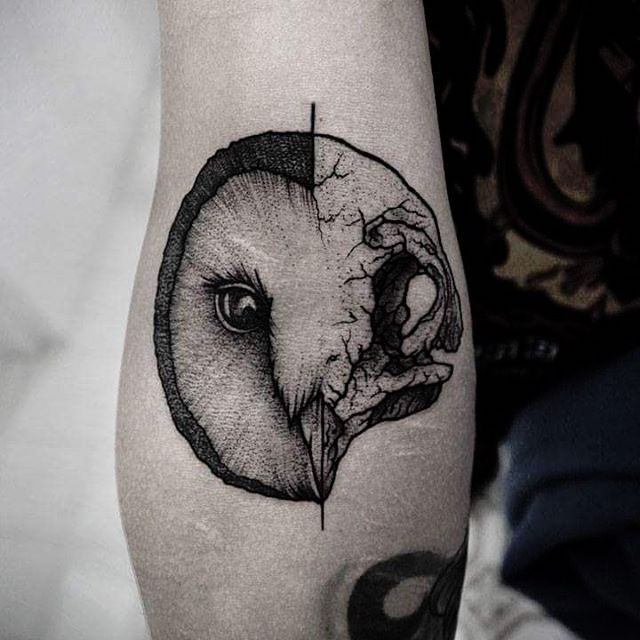 Engraving style black ink arm tattoo of half owl half skull