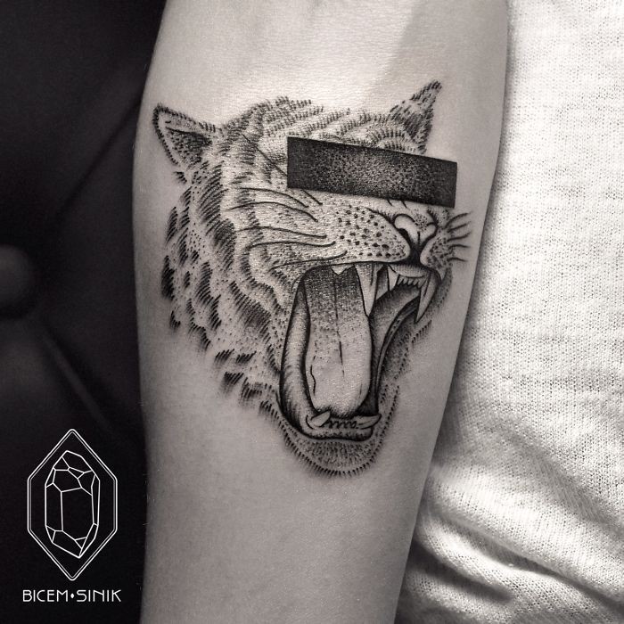 Engraving style black ink arm tattoo of lion head with black bar
