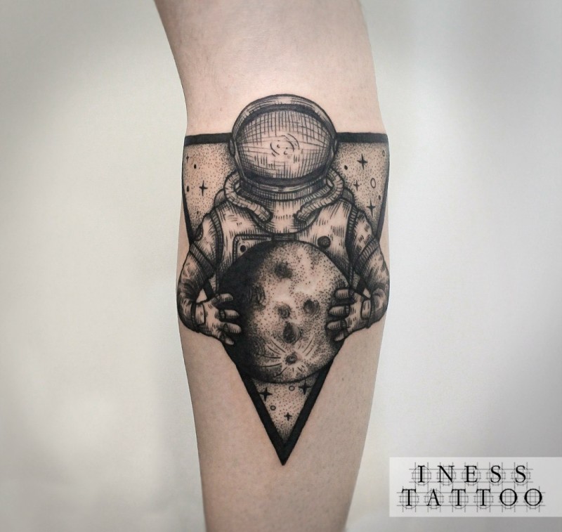 Engraving style black ink arm tattoo of astronaut with moon and triangle