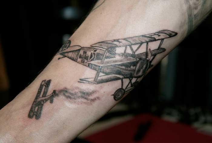 Engraving style black ink arm tattoo of WW1 planes