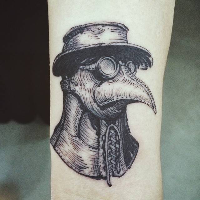 Engraving style black ink arm tattoo of plague doctors helmet