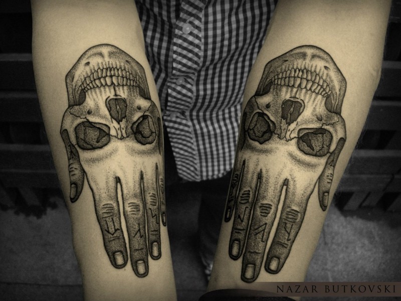 Engraving style black ink arms tattoo of humans hand with skull