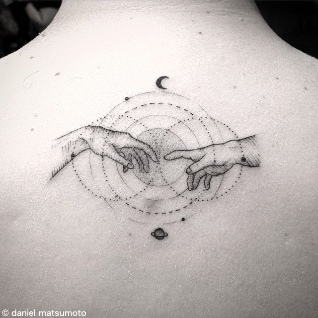 Engraving style black ink back tattoo of hands with planets