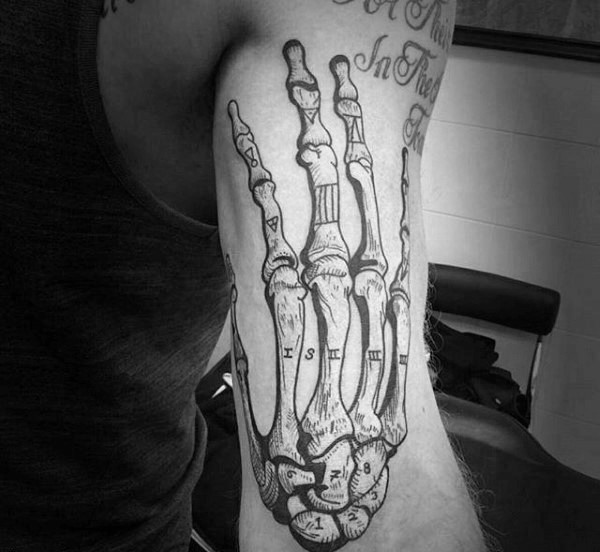 Engraving style black ink biceps tattoo of human skeleton hand