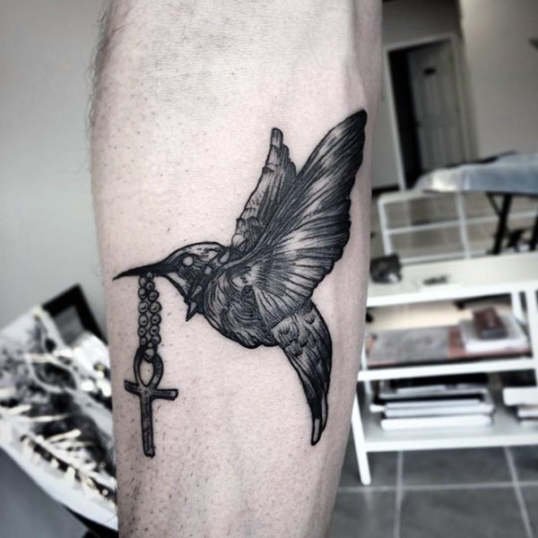 Engraving style black ink bird with cross tattoo