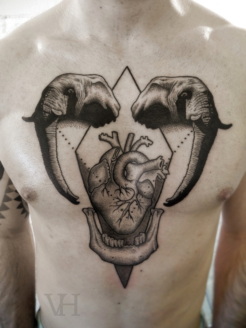Engraving style black ink chest tattoo of human heart with elephant heads