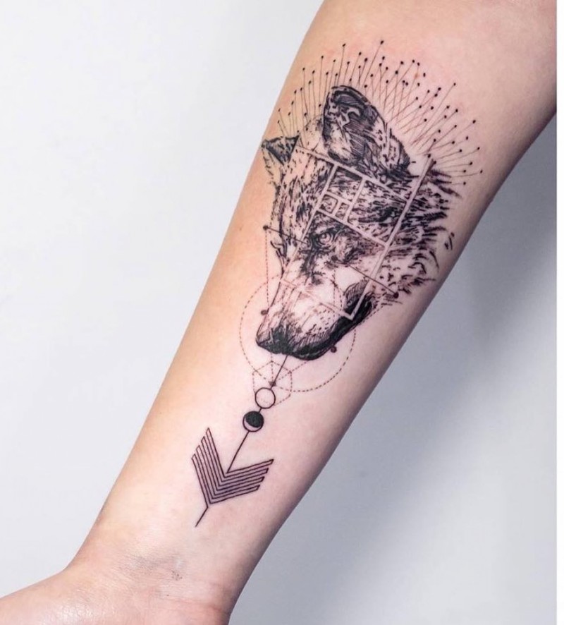 Engraving style black ink forearm tattoo of wolf head with ornaments