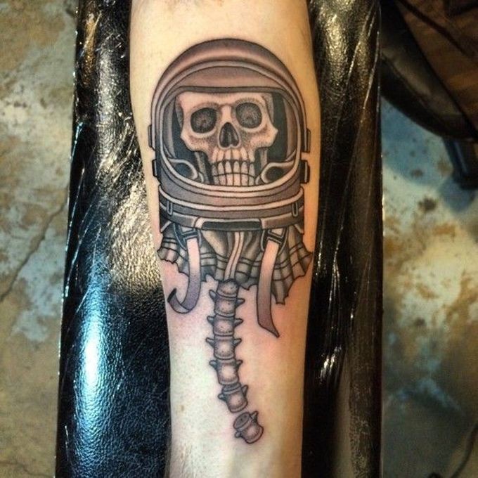 Engraving style black ink forearm tattoo of creepy astronaut skeleton