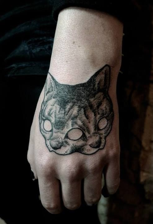 Engraving style black ink hand tattoo of creepy cat mask