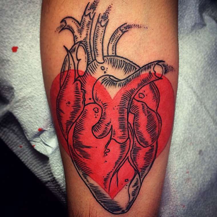 Engraving style black ink heart tattoo combined with red heart