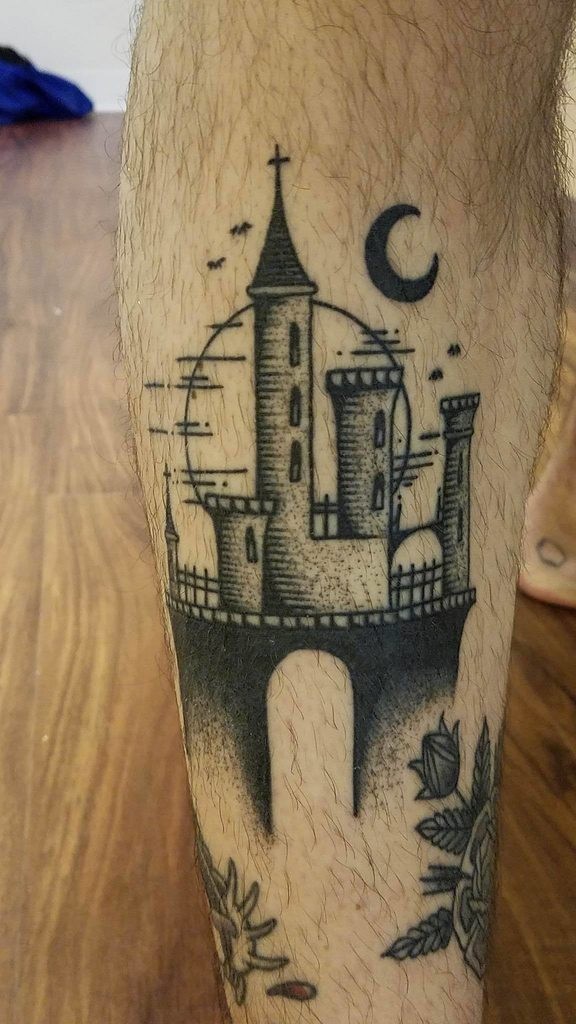 Engraving style black ink leg tattoo of fantasy castle with moon