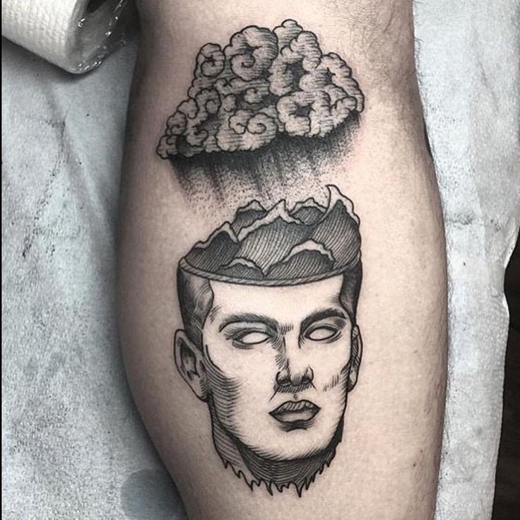 Engraving style black ink leg tattoo of man face with cloud