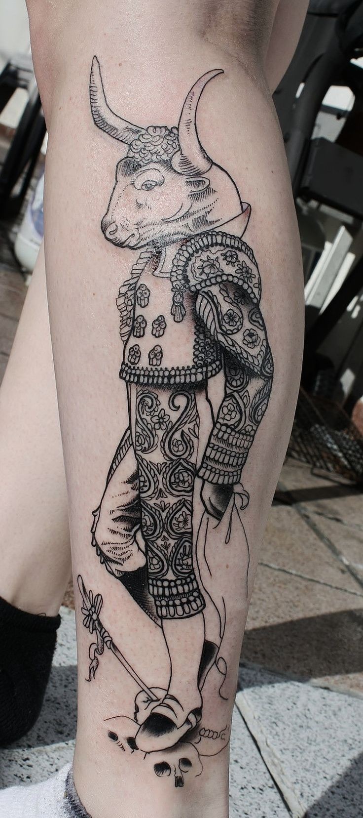 Engraving style black ink leg tattoo of saint bull in clothes