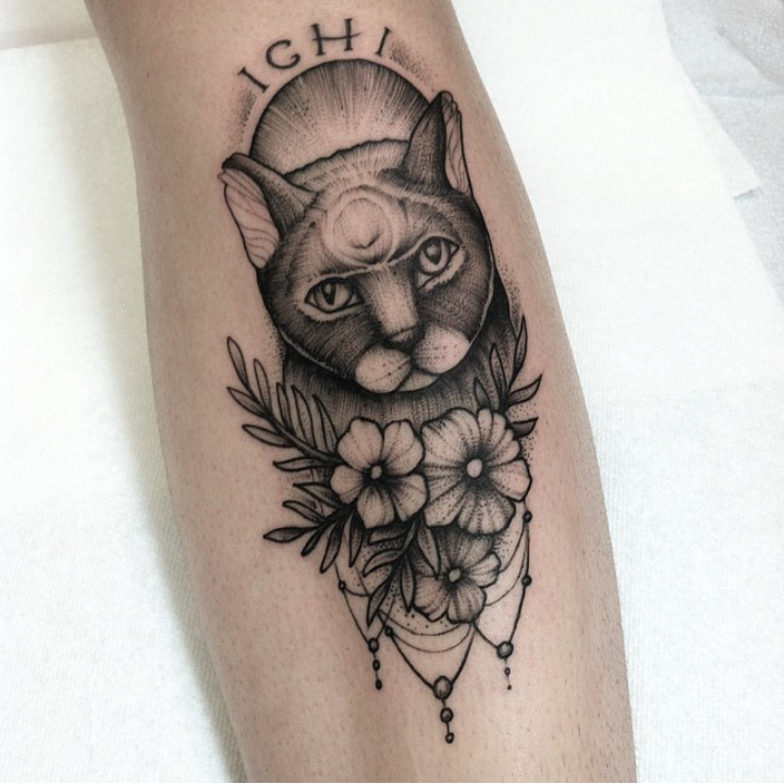 Engraving style black ink leg tattoo of stunning cat with flowers and lettering