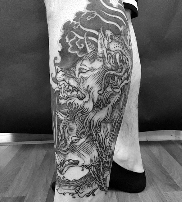 Engraving style black ink leg tattoo of Cerberus with chain