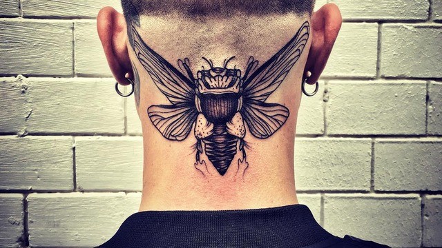 Engraving style black ink neck tattoo of big insect