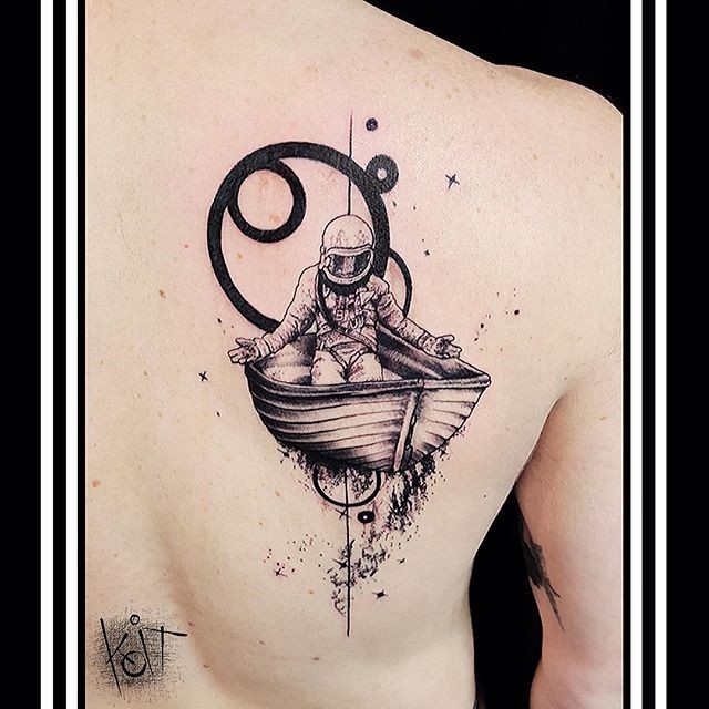 Engraving style black ink scapular tattoo of space man in ship