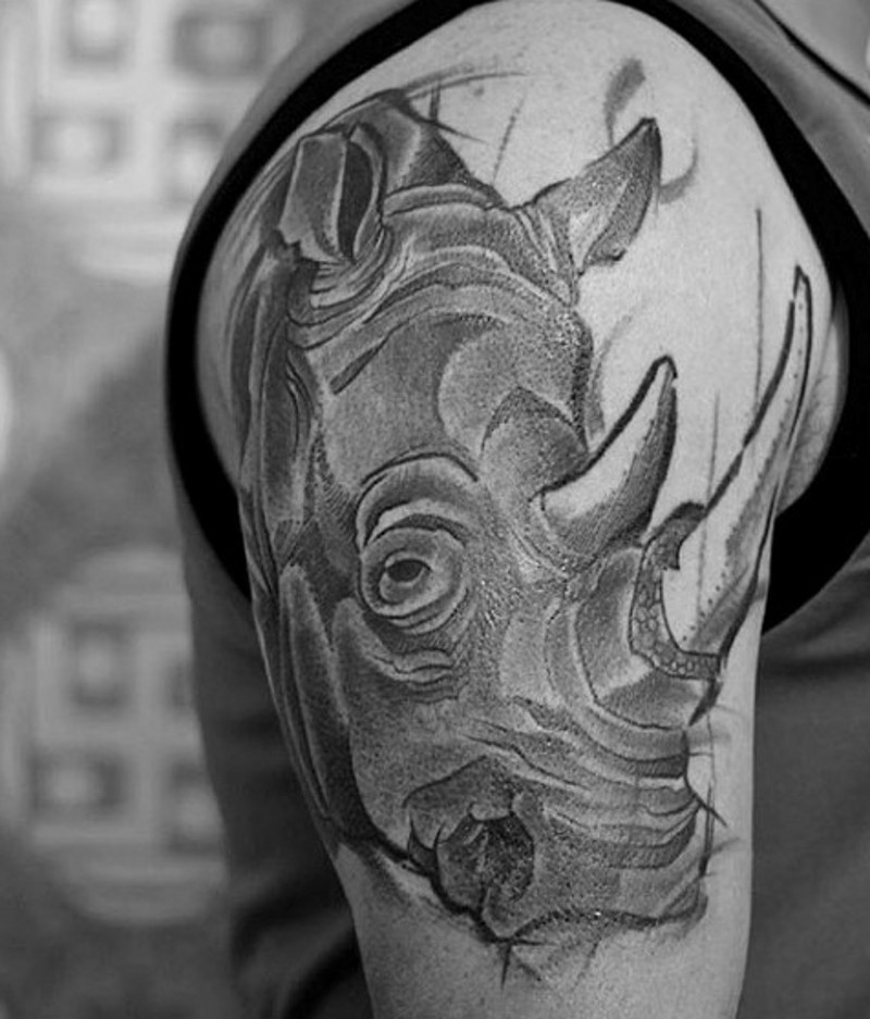 Engraving style black ink shoulder tattoo on rhino head