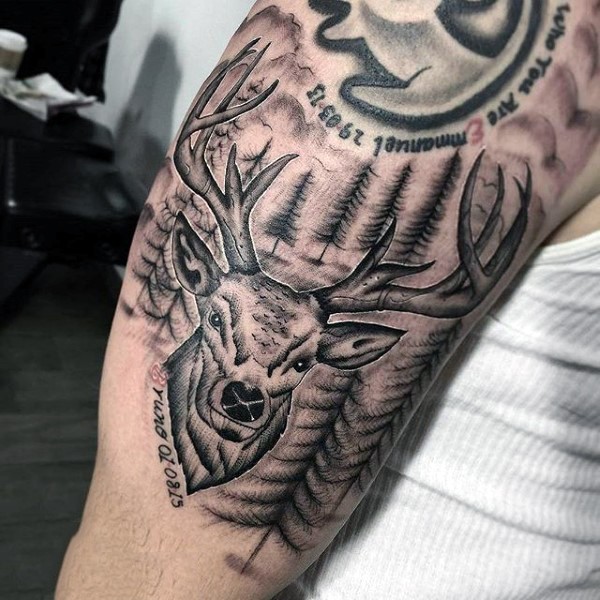 Engraving style black ink shoulder tattoo of deer with forest and lettering